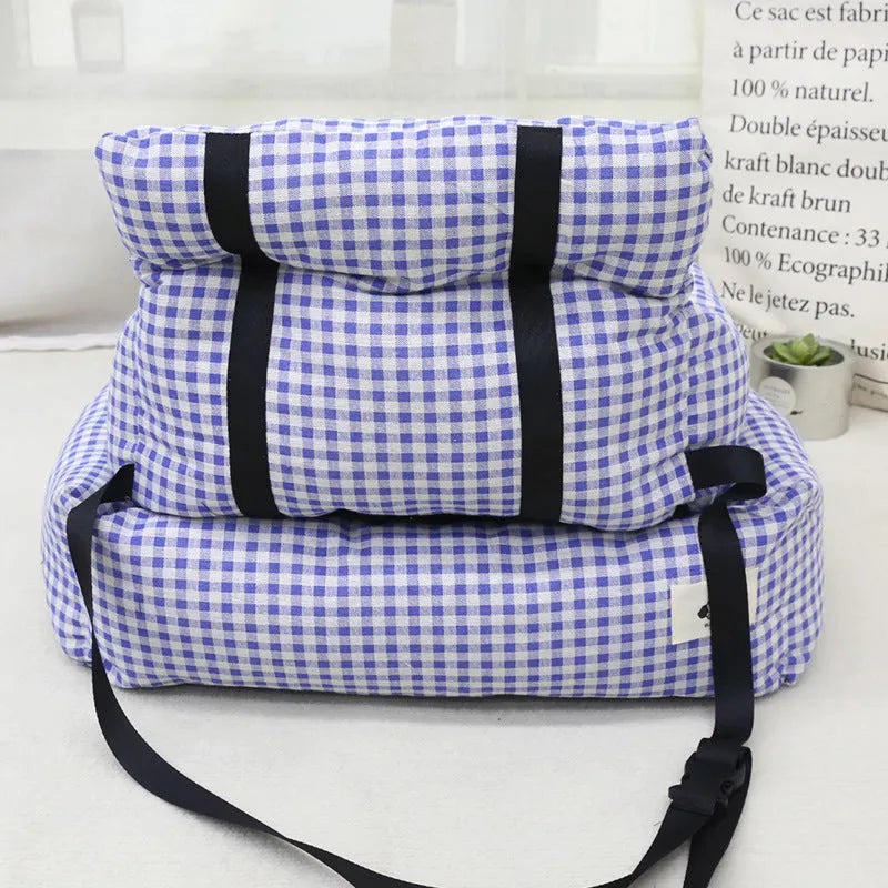 Car-mounted pet outing nest in grey and blue plaid options showing stain-resistant cloth construction