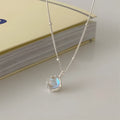 Silver geometric ornamental stone pendant on a curb chain necklace for women.