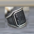 Unisex black alloy ring with copper inlay and a zircon stone.