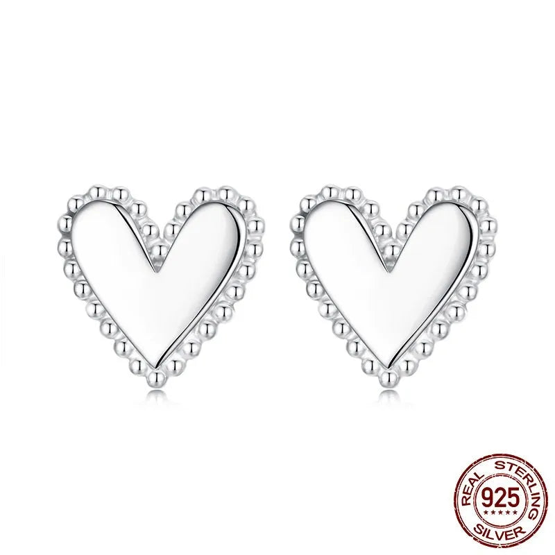 Simple S925 sterling silver heart-shaped ear studs with electroplated finish on a white background