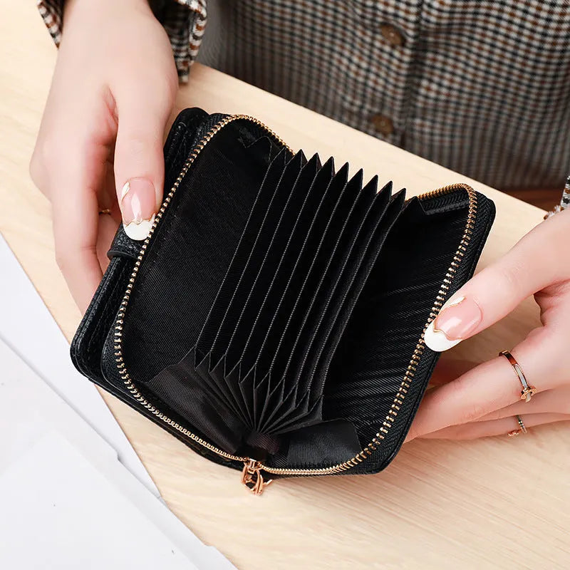 Beige ladies short wallet with a textured lychee pattern, shown in a two-fold open position.