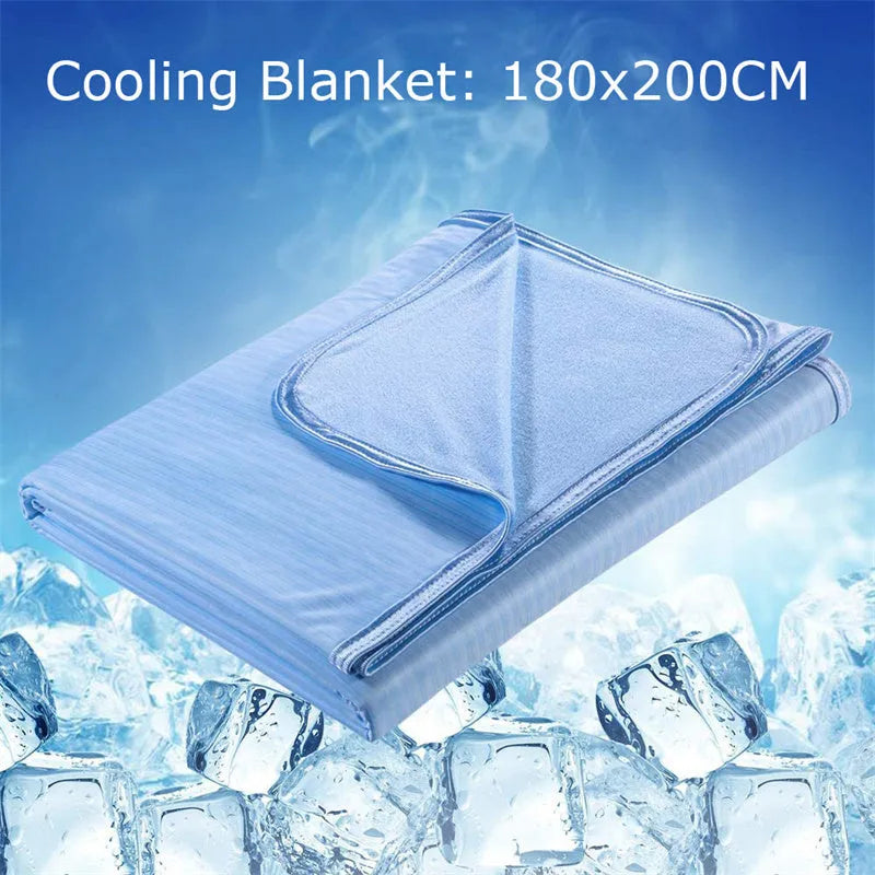 Blue and grey polyester cooling blanket with Japanese Q-Max fibres on a bed.