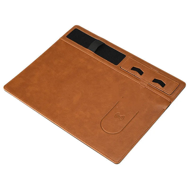 Pink wireless charging mouse pad with phone holder on a desk, showing USB cable and 320mm x 260mm size.