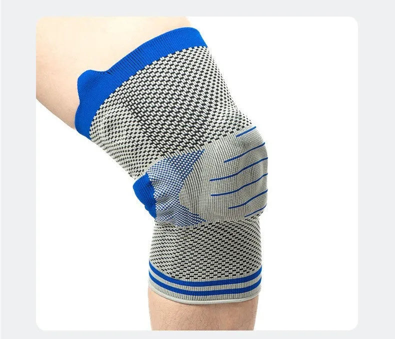 Black and gray knee pad with silicone shock absorber for sports protection on a leg.