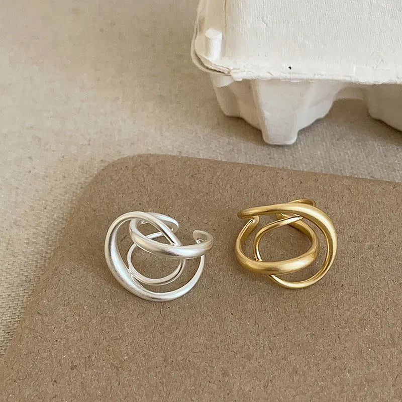 Three-dimensional interlaced geometric open ring in matte metal with gold electroplating