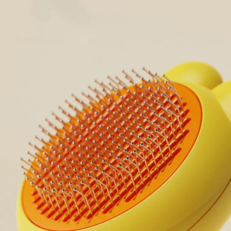 Green self-cleaning cat brush with metal comb and release button for pet grooming.