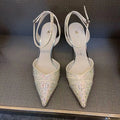 Women's black pointed toe high heels with a hollow stiletto heel and red sole, shown from the side.