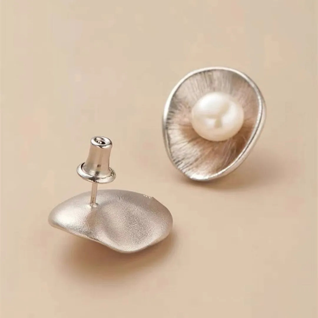 Gold electroplated sterling silver pearl ear studs with geometric design and surgical steel posts