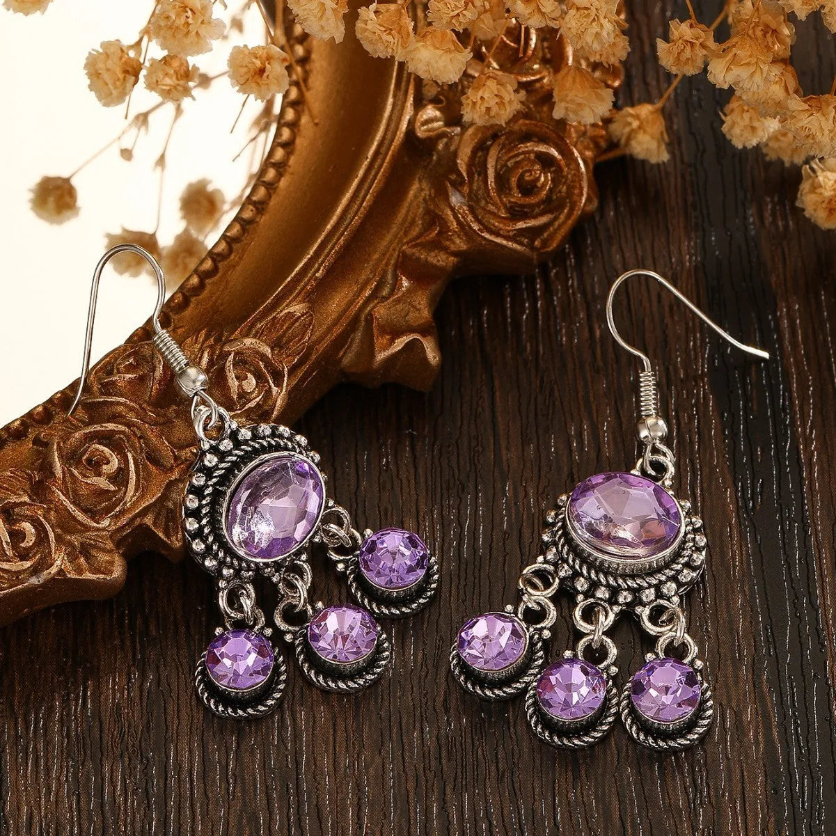 Long tassel alloy earrings in Dark Violet colour with hook fitting, hanging against a light background