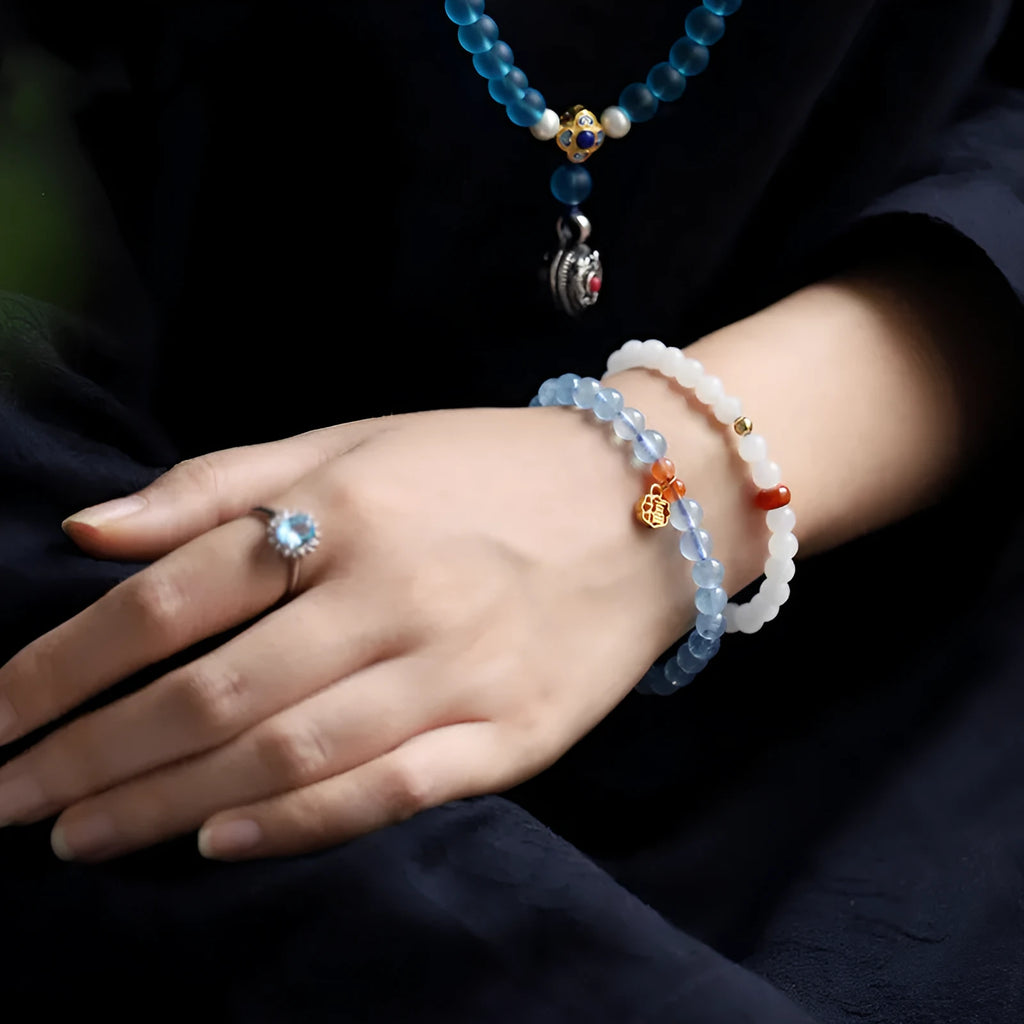 Ice translucent aquamarine crystal bracelet with 8mm round beads and sequins on a wrist.