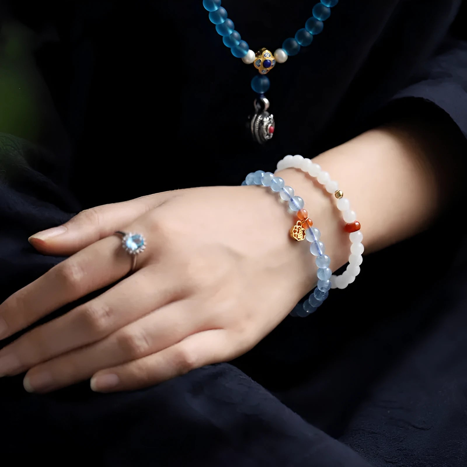 Ice translucent aquamarine crystal bracelet with 8mm round beads and sequins on a wrist.