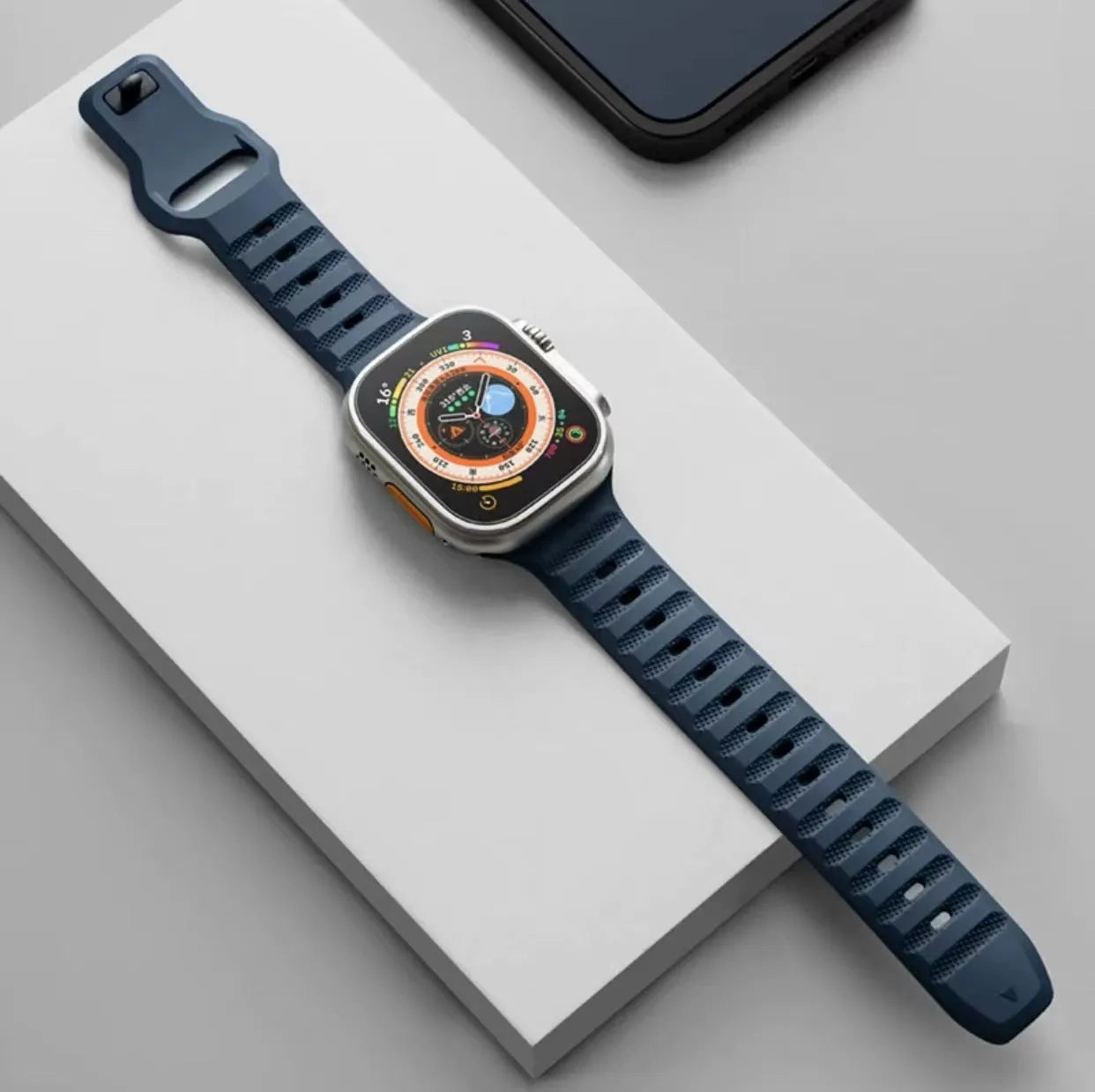 Third-party fluoro rubber Apple Watch strap with T-buckle in multiple colours on a watch case