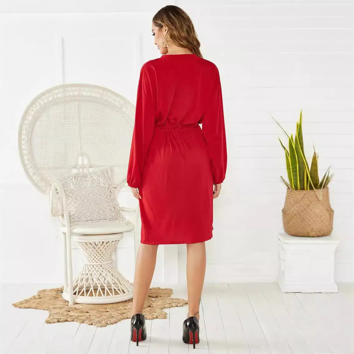 Black A-line midi dress with elastic waistband and cinched belt, long sleeves with elastic cuffs