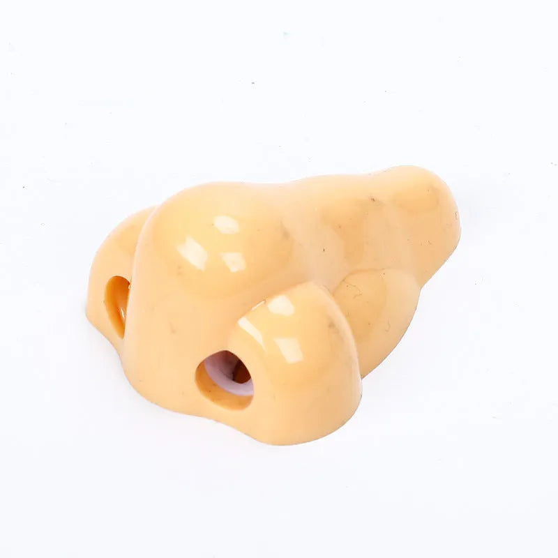 Flesh colour plastic pencil sharpener showing geometry shape and big nostril opening