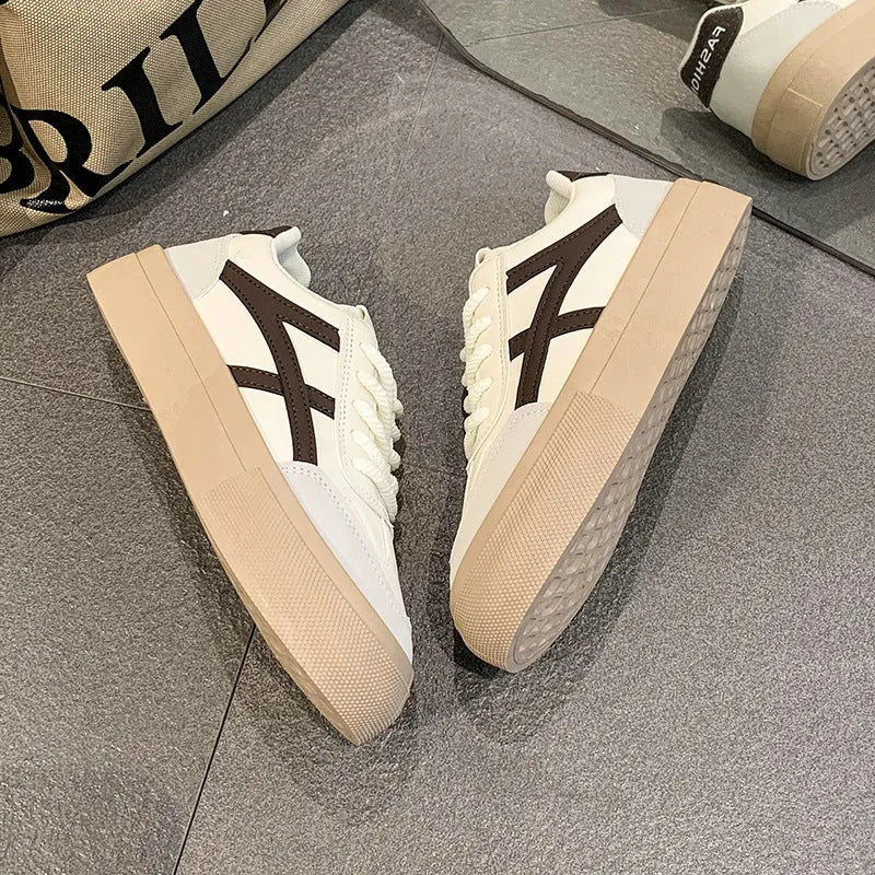 Brown and blue low-top lace-up casual shoes with a patent leather finish and round toe.