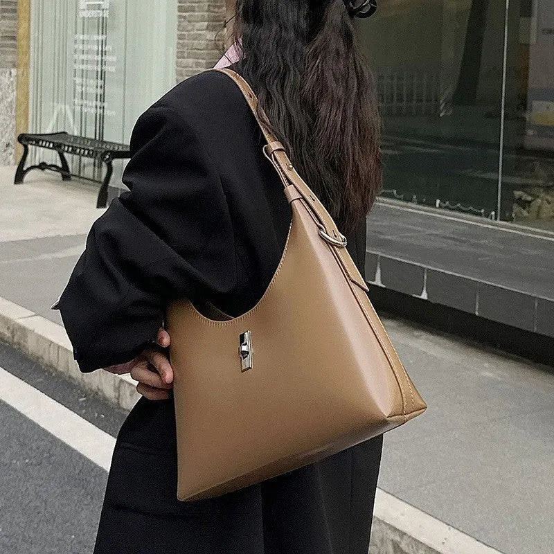 Soft genuine leather crossbody shoulder bag in a dumpling shape, shown in one of six available colours.