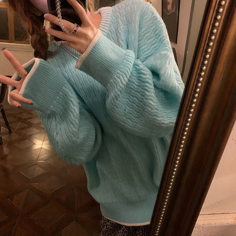 Women's loose blue pullover sweater with regular sleeves on a hanger
