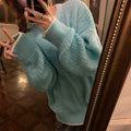 Women's loose blue pullover sweater with regular sleeves on a hanger