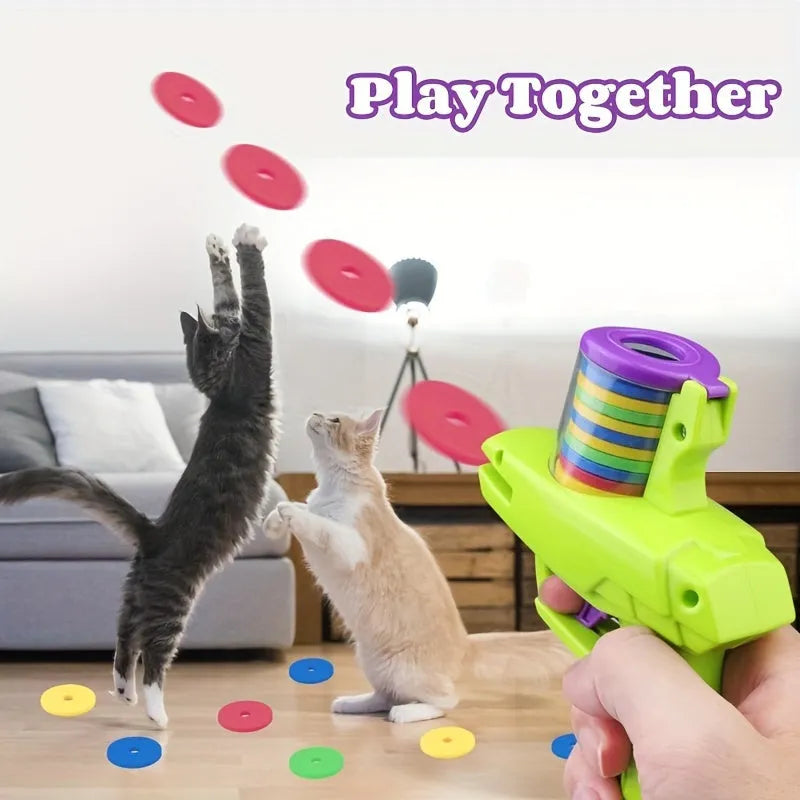 Green durable plastic cat toy launcher with a foam disc ready for launch.
