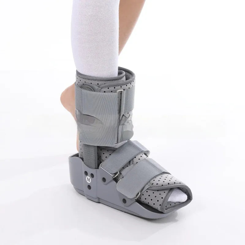 Grey and black Achilles tendon rehabilitation boot with plastic shell, adjustable straps, and rubber sole.