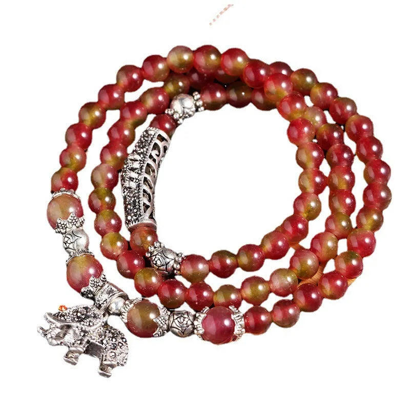 Natural watermelon crystal bracelet with Chinese knot fastening showing bi-colour gemstone beads