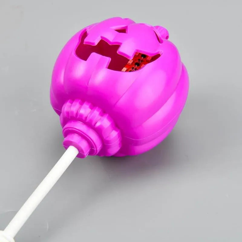 Plastic pumpkin lamp with USB charging port displaying yellow or purple light option