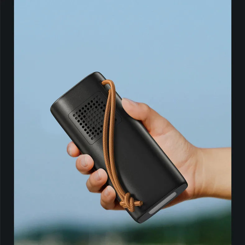 Black portable power bank with 20000mAh capacity, 220V output, and solar panel input for outdoor charging.