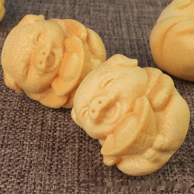 Solid bamboo carving ornament of a cute ingot pig, 4cm tall by 3.5cm diameter.