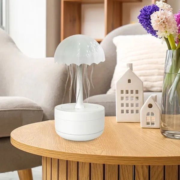 White jellyfish-shaped humidifier and essential oil diffuser with colourful LED night light on desktop