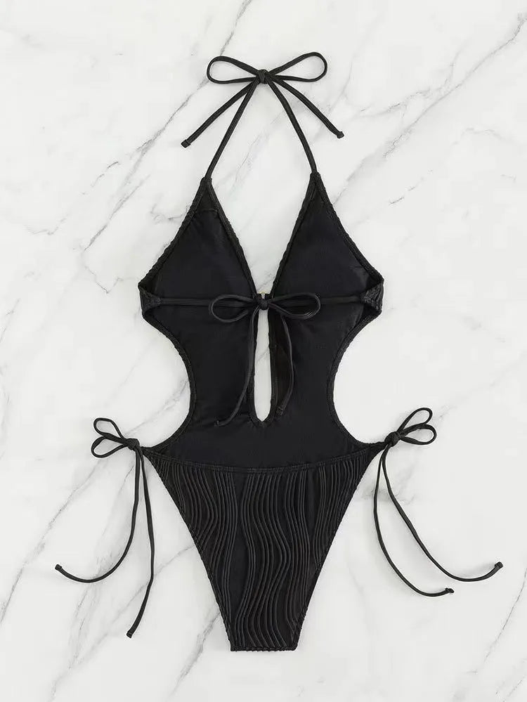 Women's black lace-up triangle bikini swimsuit on white background
