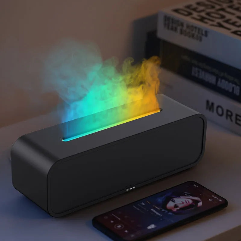 White aroma diffuser with colour-changing lights on a wooden table next to its remote control.