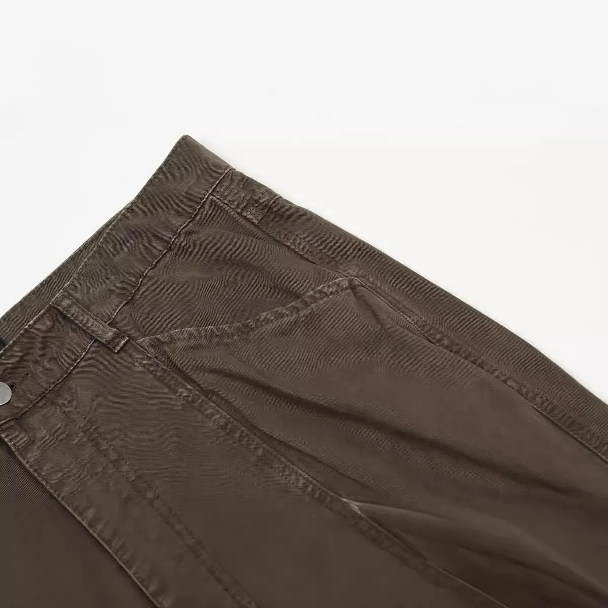 Men's brown loose straight wide-leg high-waisted cotton trousers laid flat.