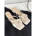 Women's cream white sandals with chunky heel, square toe, and a single satin strap.