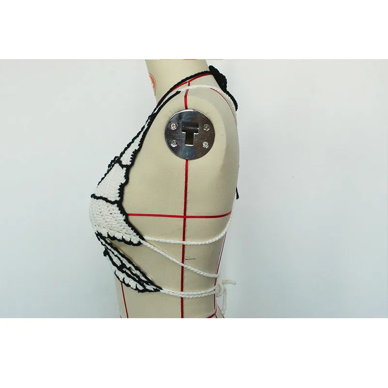 Women's classic black and white bikini swimsuit on a hanger.