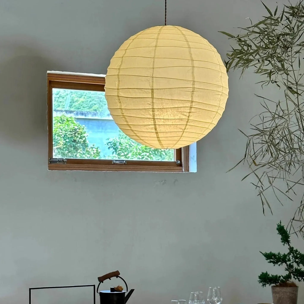 Japanese-style spherical rice paper chandelier pendant light in a living room setting.