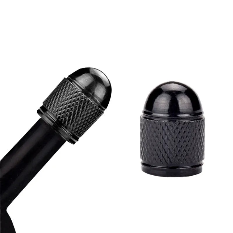 A single aluminium mountain bike tyre valve cap shown in a choice of five colours: black, blue, gold, red, and silver.
