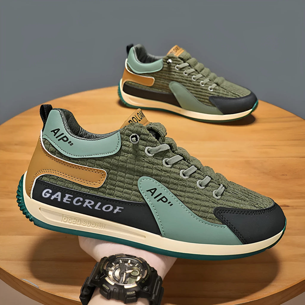 Men's grey mesh running shoes with round toe and lace-up closure on sports surface