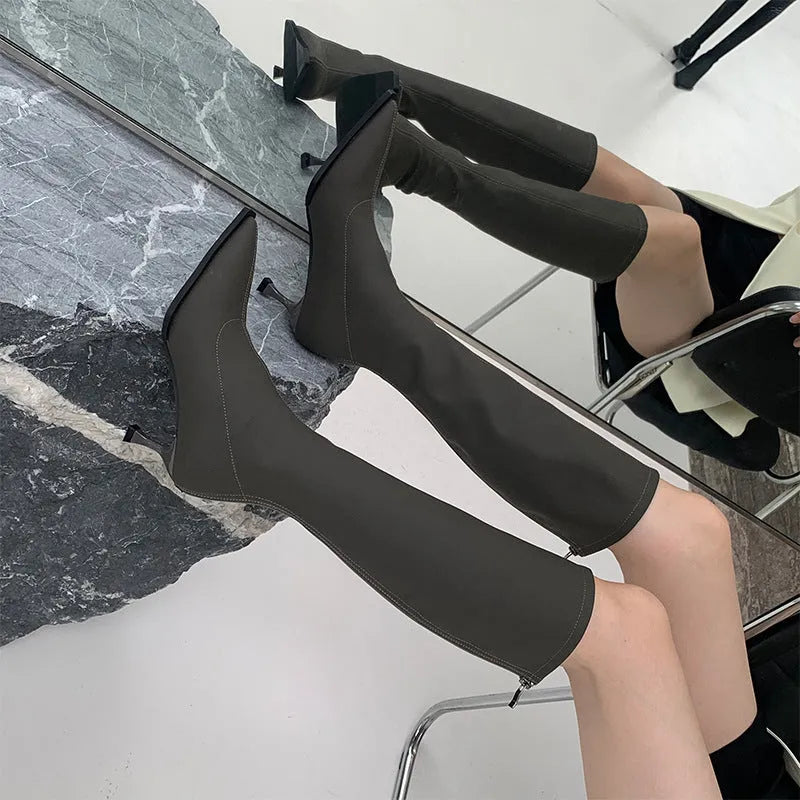 Women's black pointed toe ankle boots with a stiletto heel and a back zipper fastening.