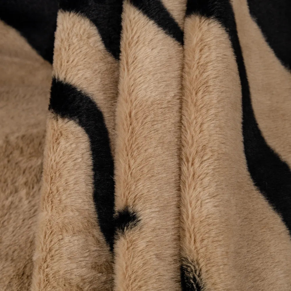 Zebra pattern flannel sofa cover in a caramel colour, shown draped over a sofa.