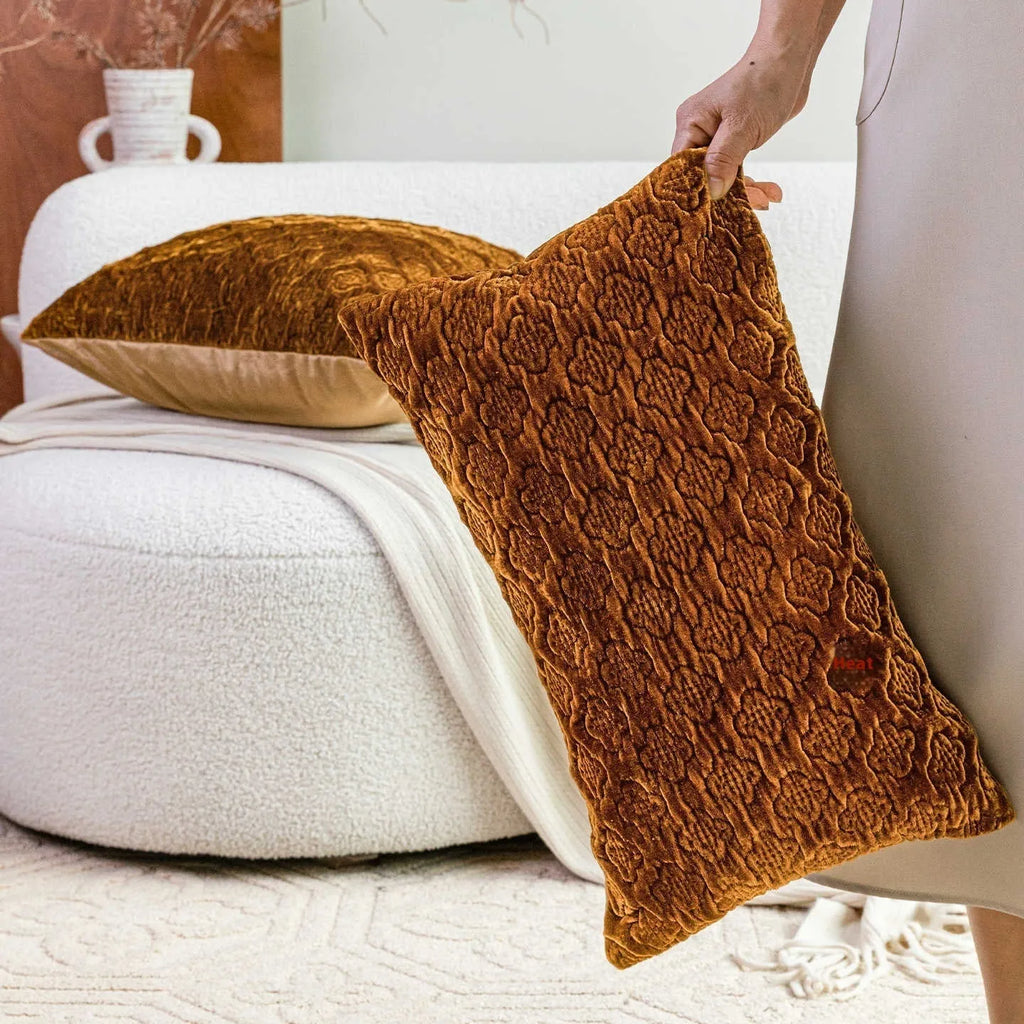 Brown gold antique-style quilted square cushion pillow and matching lumbar pillow on a sofa.
