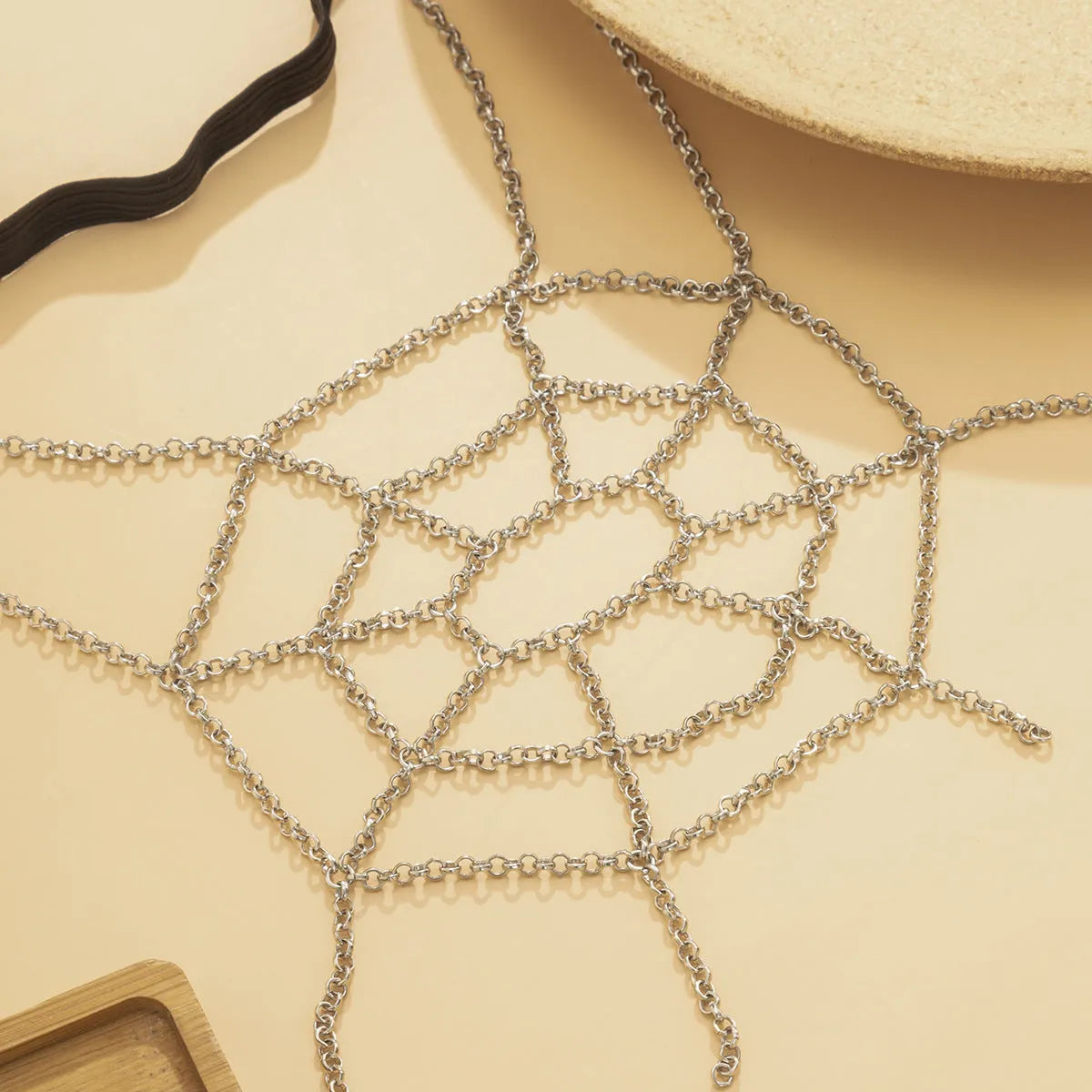 Women's simple geometric body chain in silver electroplated alloy, shown as an anklet