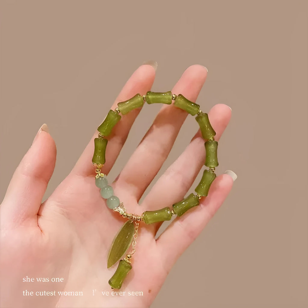 Chinese style glass bead bracelet with bamboo leaf design and manual craftsmanship details.