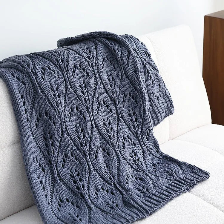 Nordic style knitted acrylic throw blanket 127x152cm in milky white on a sofa