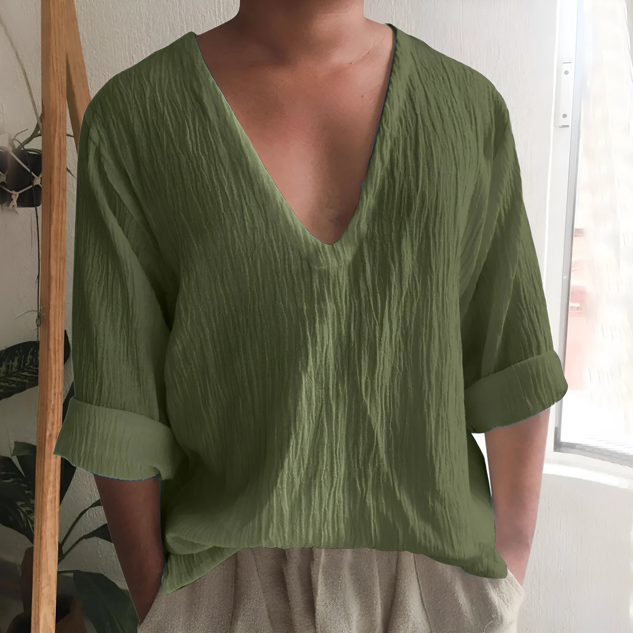 Men's solid colour V-neck long sleeve t-shirt in washed cotton linen blend on a hanger.