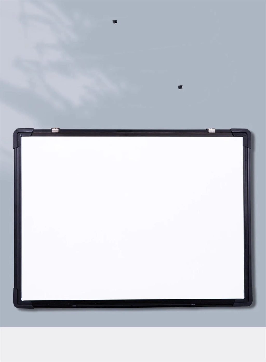 45x60cm hanging whiteboard with black frame, whiteboard pens, magnetic particles, eraser, and pen tray on a wall