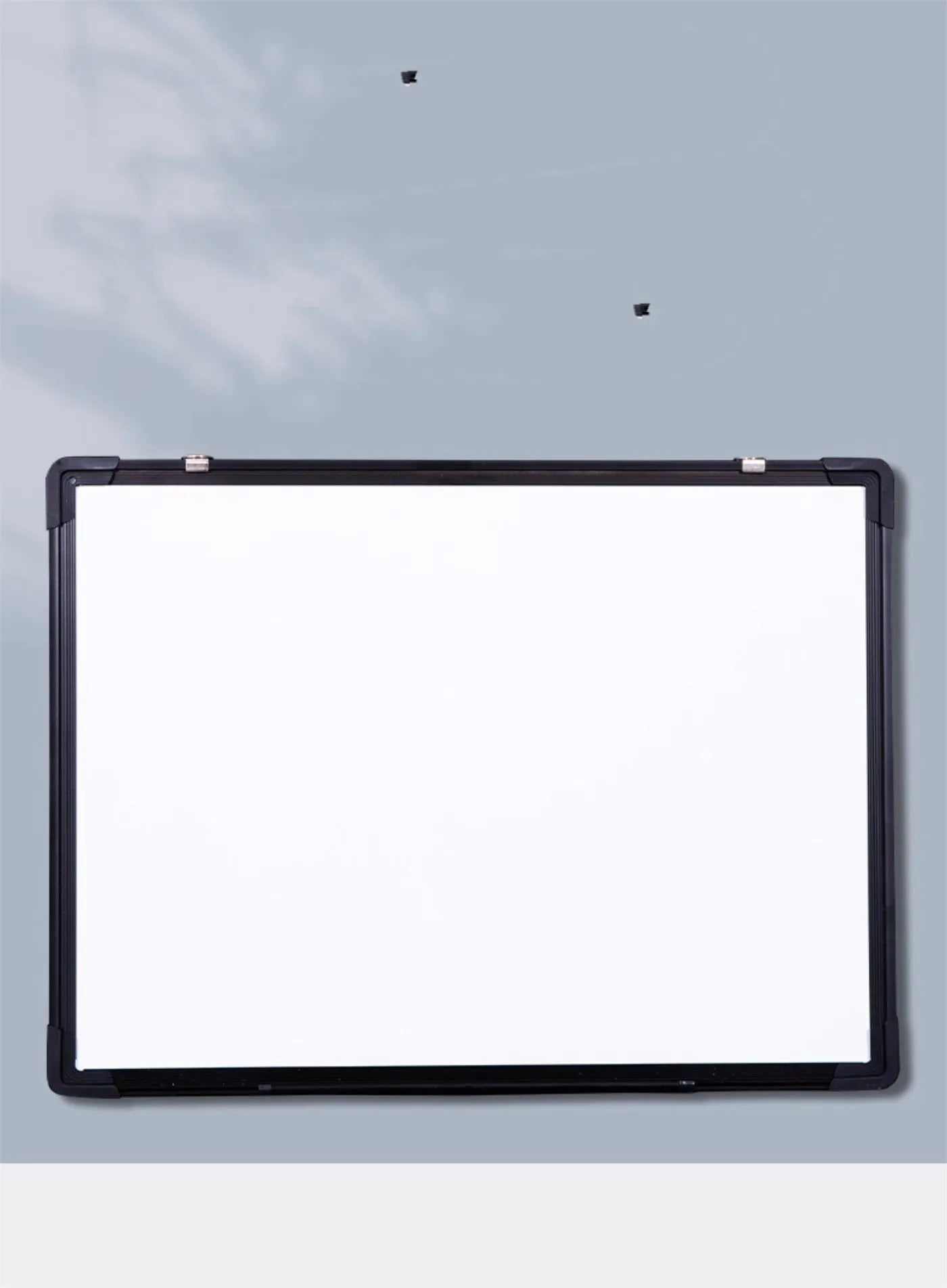 45x60cm hanging whiteboard with black frame, whiteboard pens, magnetic particles, eraser, and pen tray on a wall