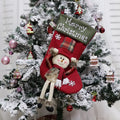Set of three large Christmas stockings with Santa, Snowman, and Reindeer 3D designs hanging on a fireplace