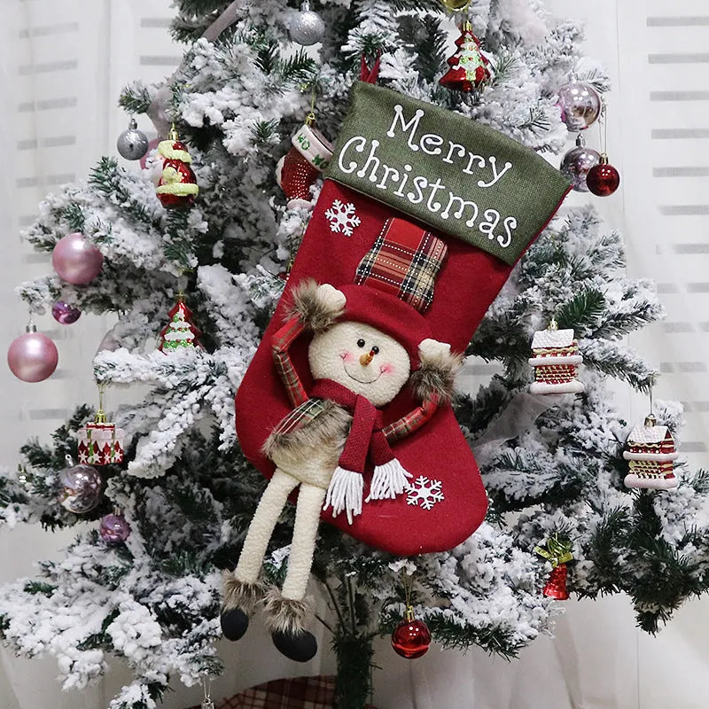 Set of three large Christmas stockings with Santa, Snowman, and Reindeer 3D designs hanging on a fireplace