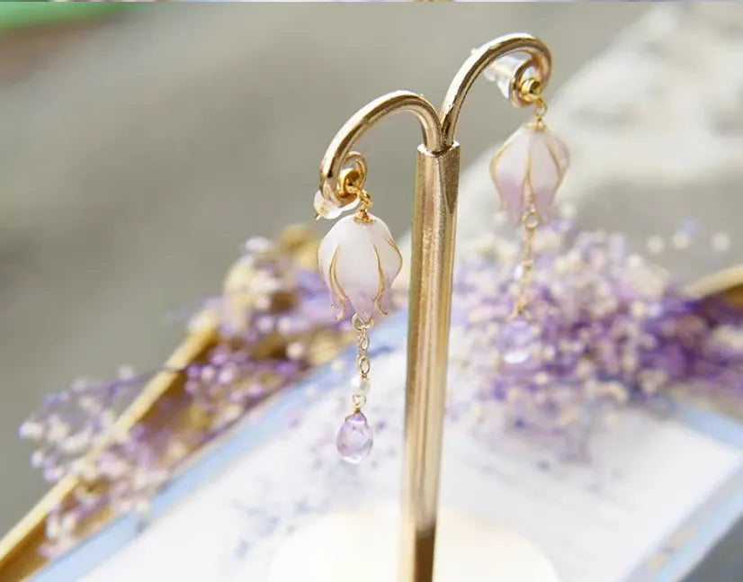 Silver plated gradient colour amethyst water drop tassel ear studs with flower core pattern on white background