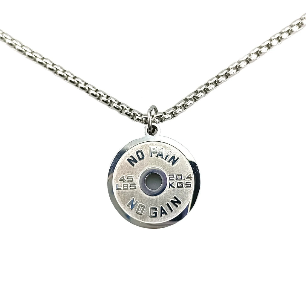 Polished stainless steel barbell disk geometric pendant necklace on a gold chain.